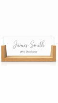Sample design: clear acrylic desk nameplate in a wooden U-shaped base, engraved with the name James Smith and the title Web Developer