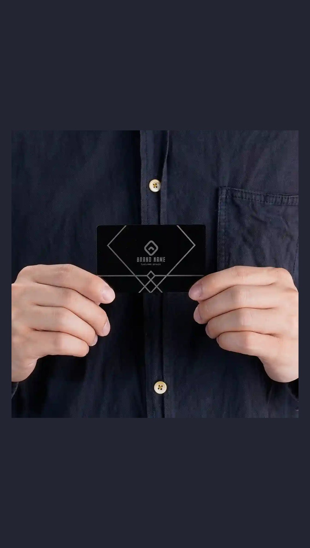 Black metal business card held in hand with sample engraving