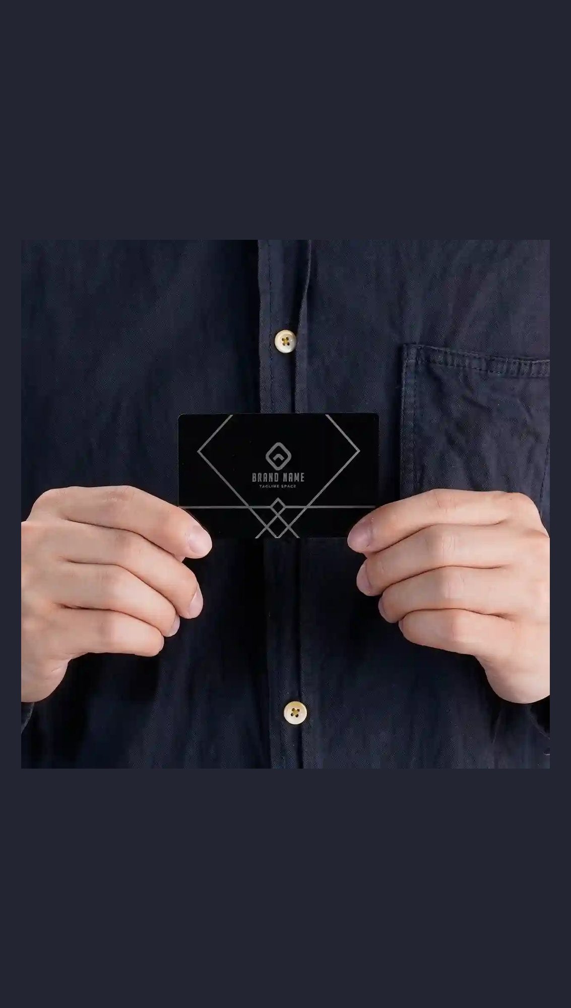 Black metal business card held in hand with sample engraving