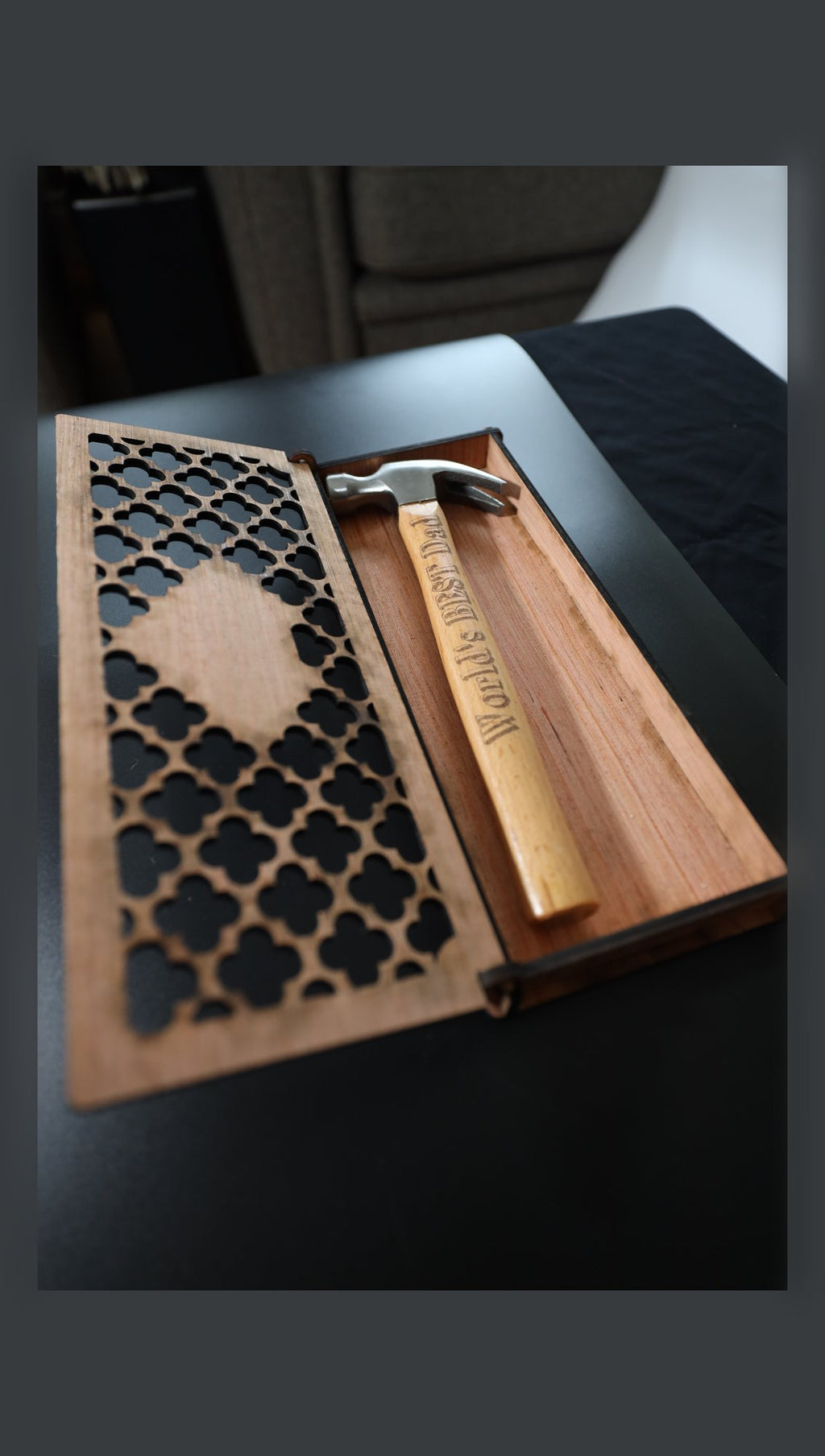 Open wooden gift box with engraved claw hammer, angled view