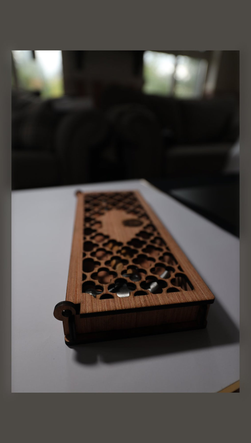 Closed wooden gift box with fretwork lid and sample lid emblem