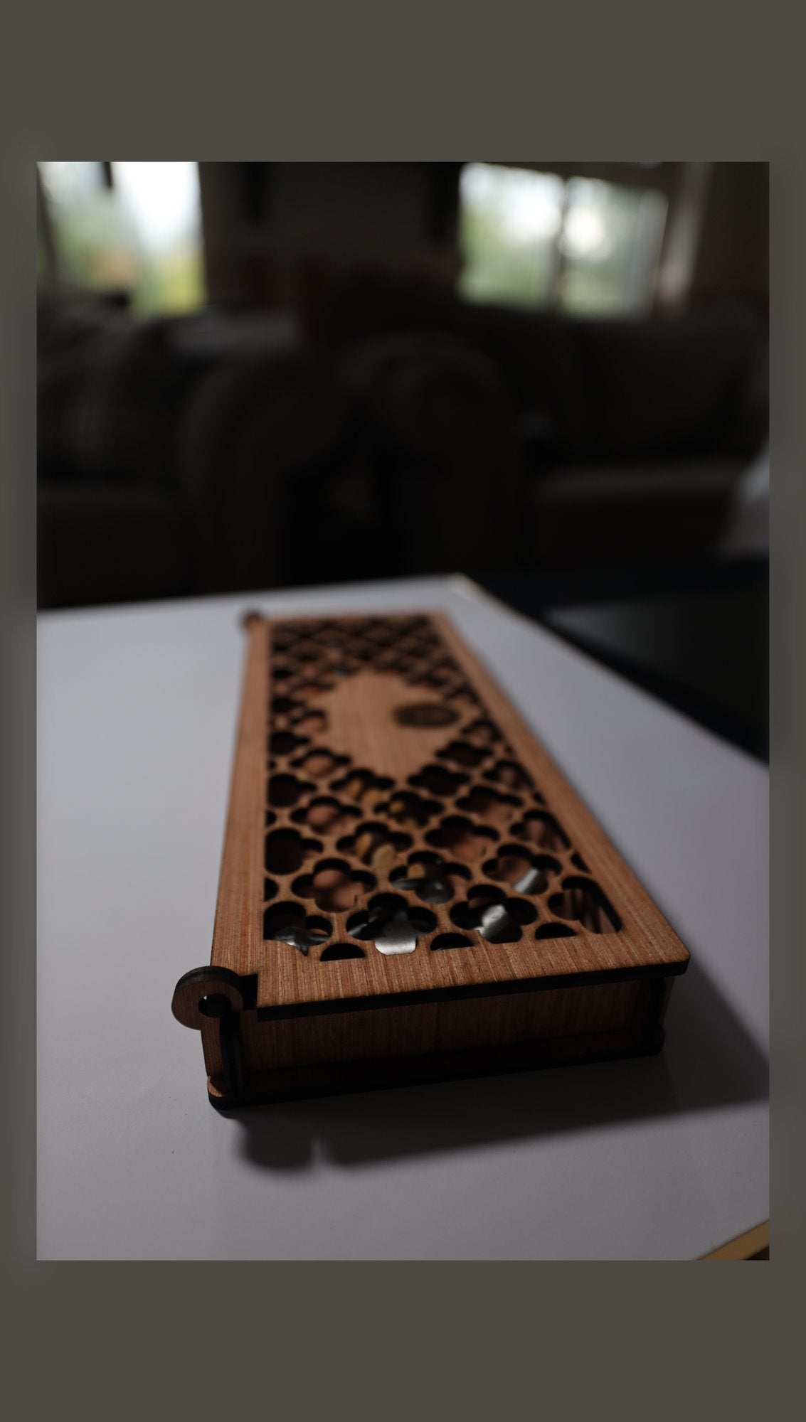 Closed wooden gift box with fretwork lid and sample lid emblem