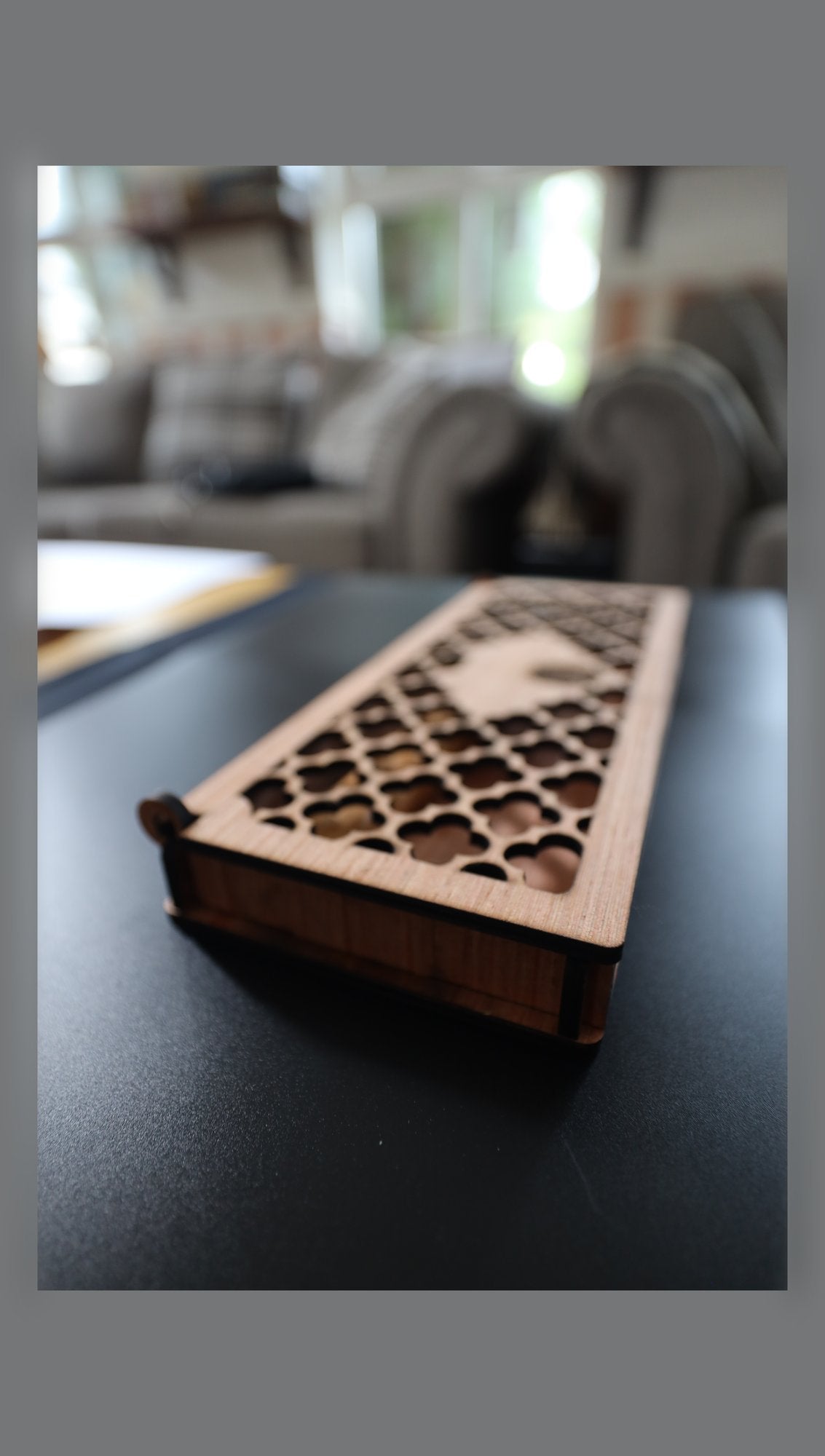 Closed wooden gift box with fretwork lid, angled view