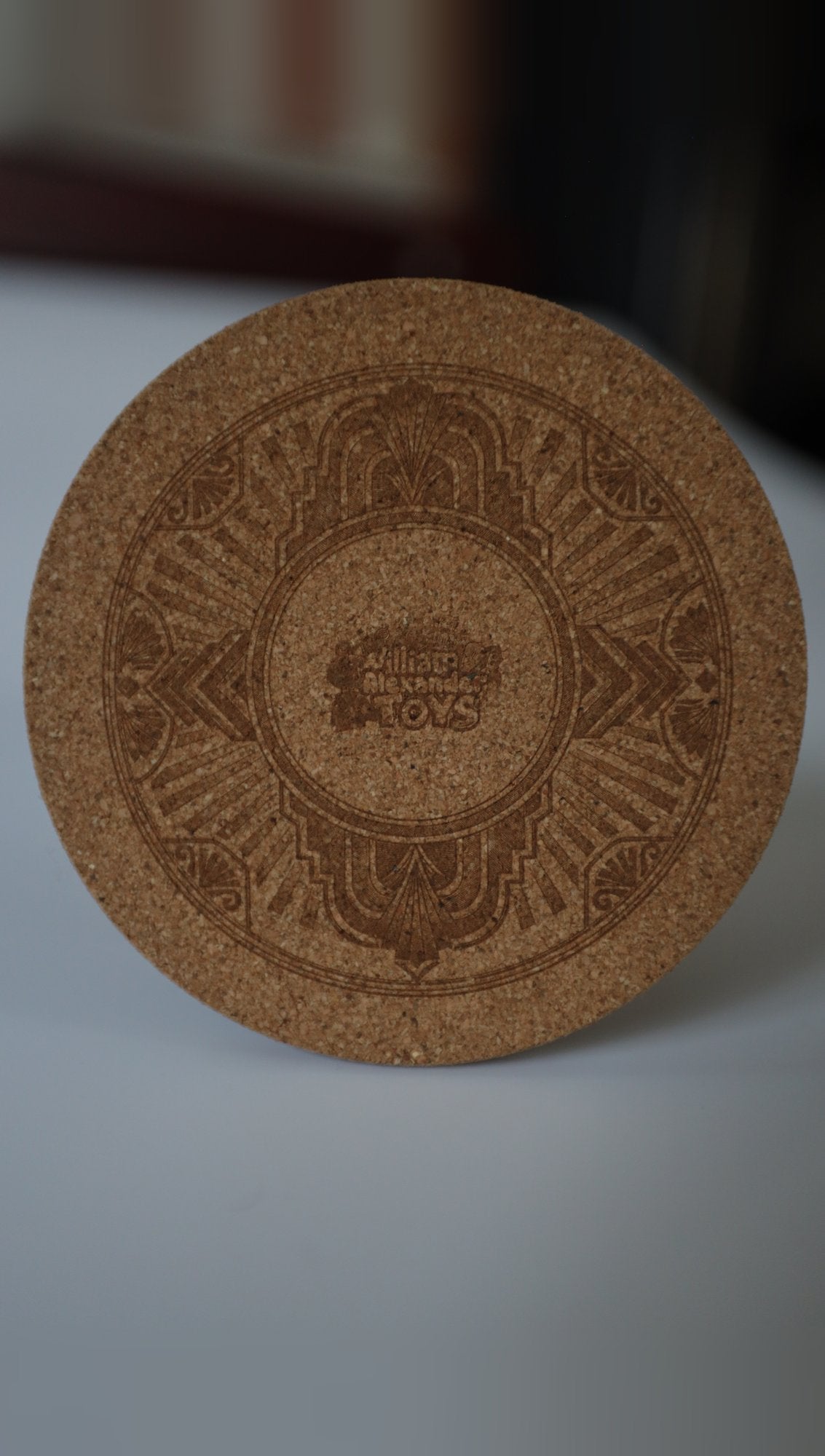 Engraved cork coaster with Art Deco design, standing upright