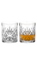 Pair of cut crystal whiskey tumblers with a sample frosted YOUR LOGO engraving on the clear band below the rim, one with whiskey