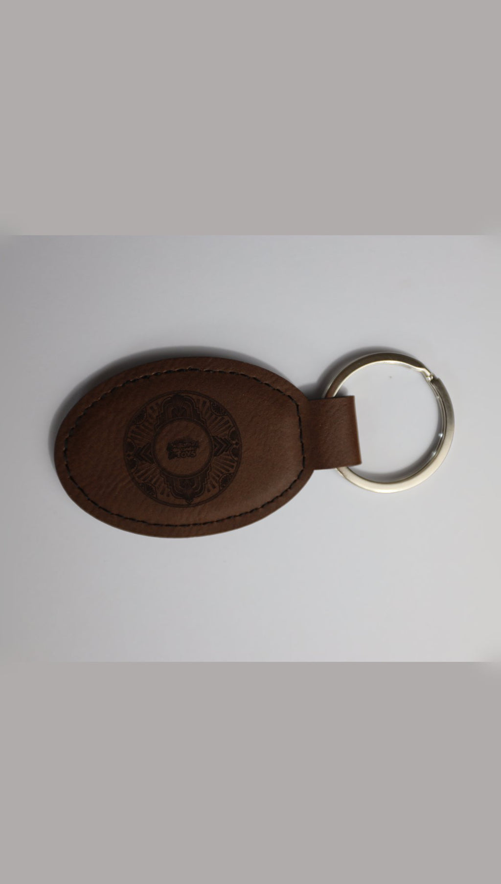 Oval faux leather keyring with sample engraving, alternative angle