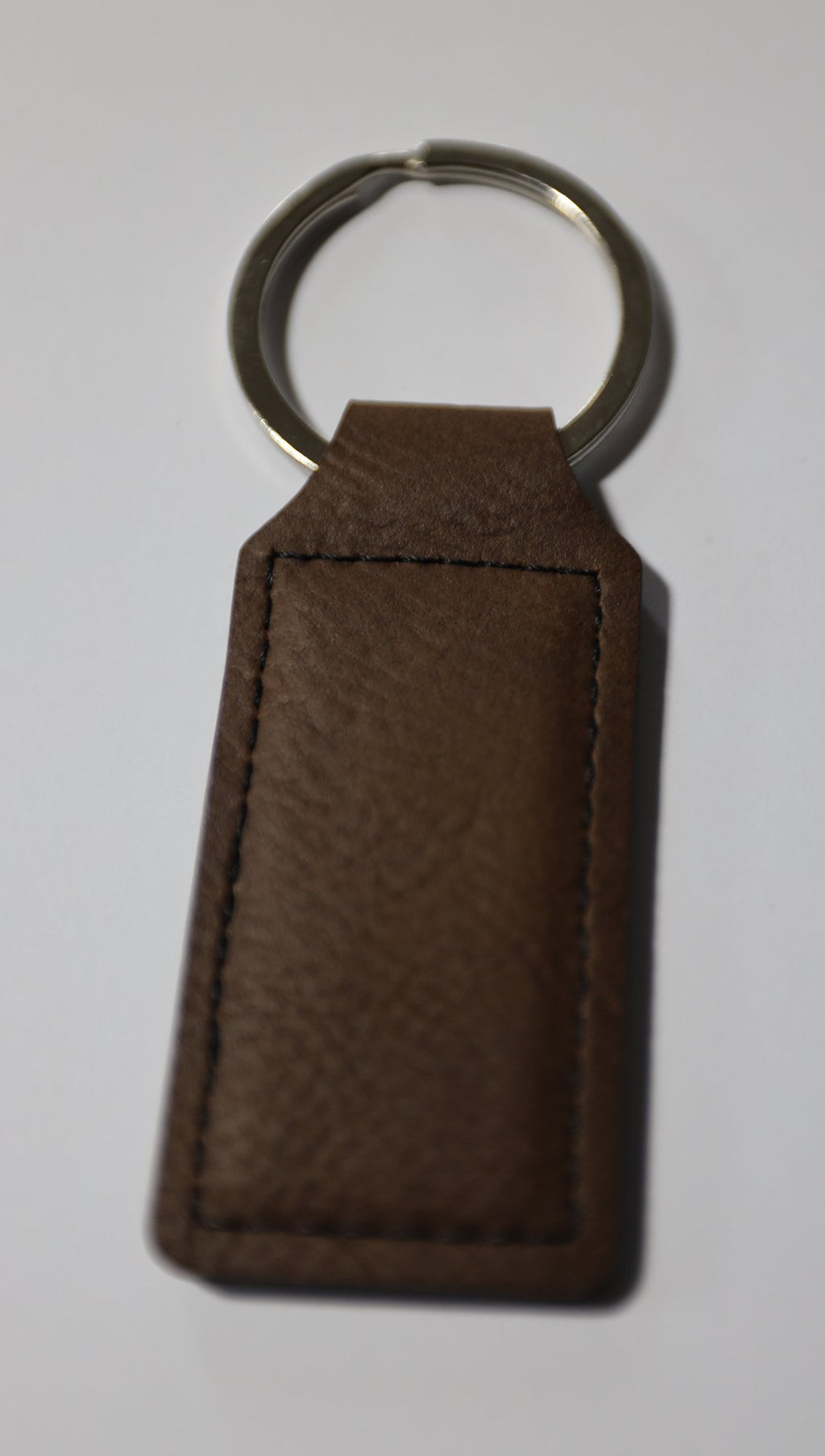 Blank brown rectangle faux leather keyring before engraving