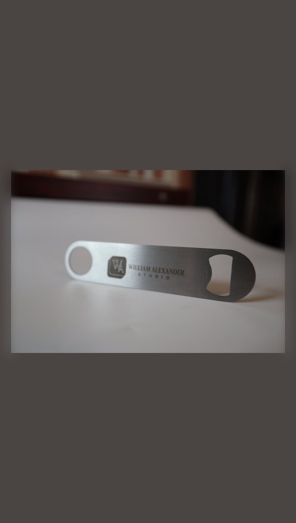 Stainless steel bar blade with sample Studio logo, angled view