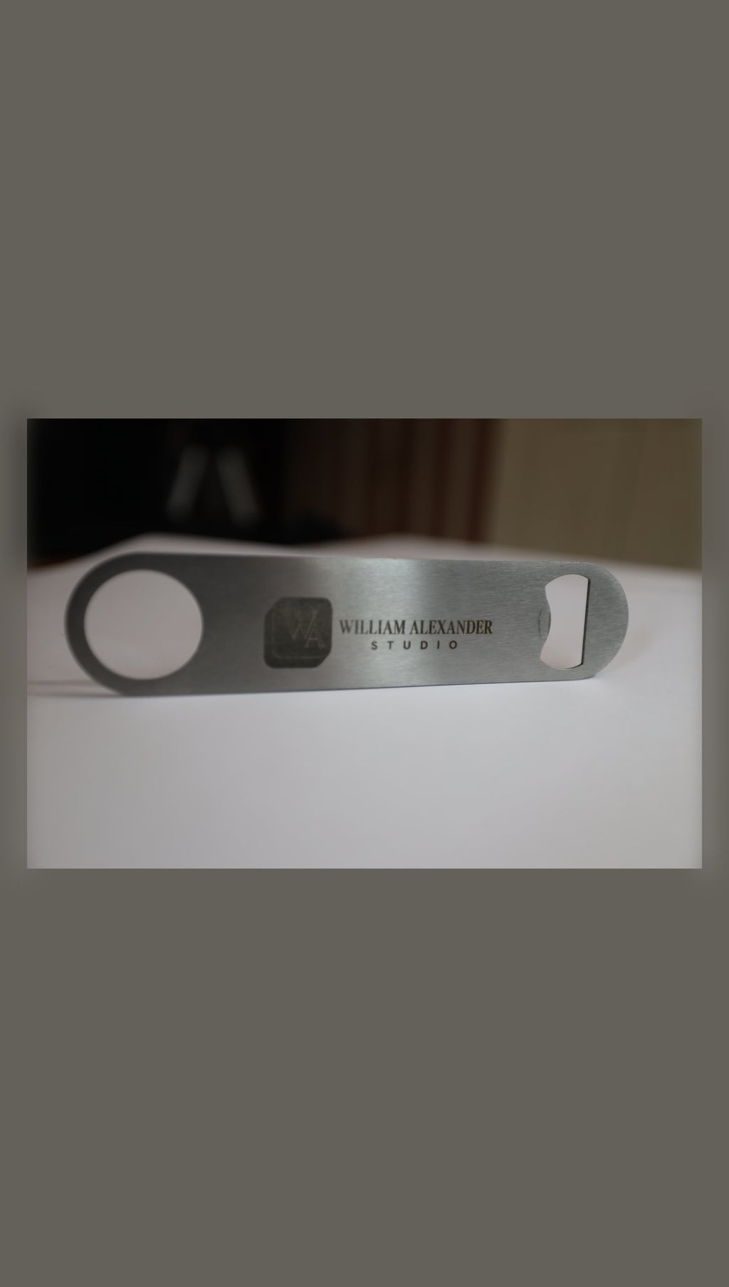 Stainless steel bar blade with sample Studio logo, side view