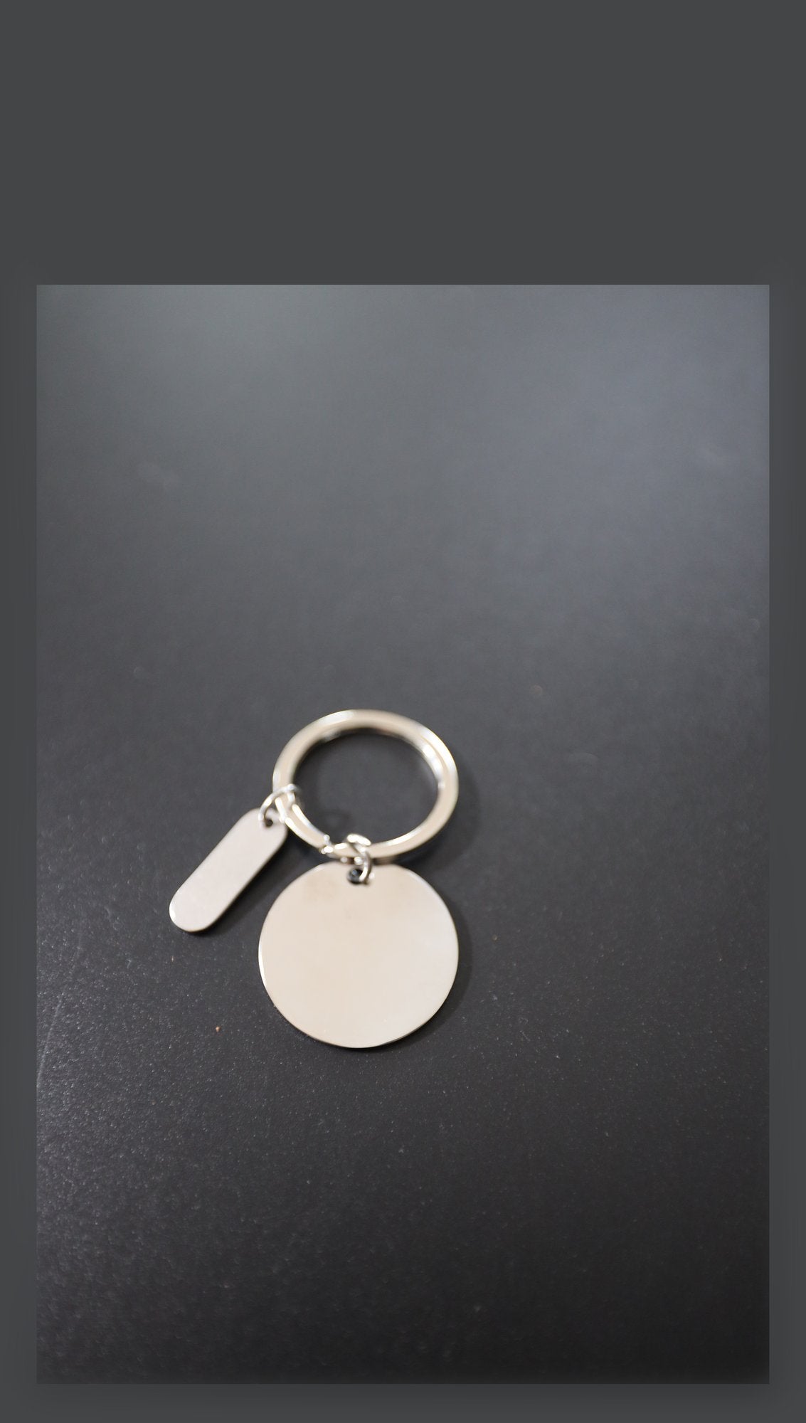 Blank stainless steel disc keyring with tag before engraving