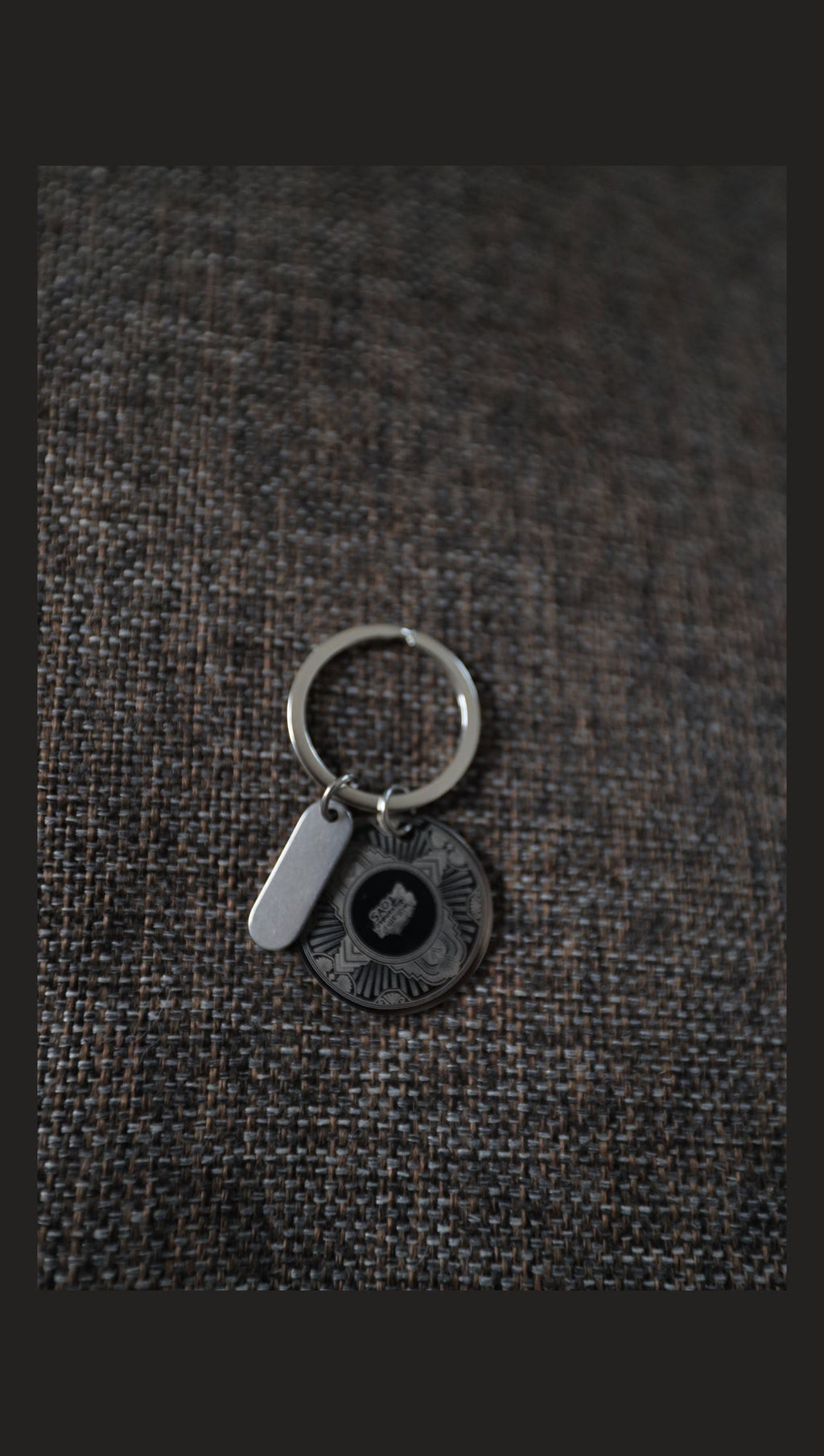 Stainless steel disc keyring with sample engraving on fabric