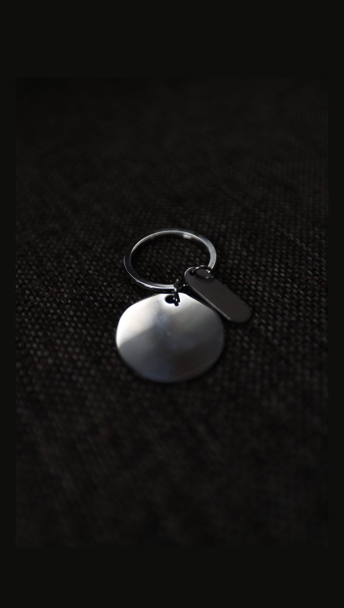 Blank stainless steel disc keyring with tag on fabric