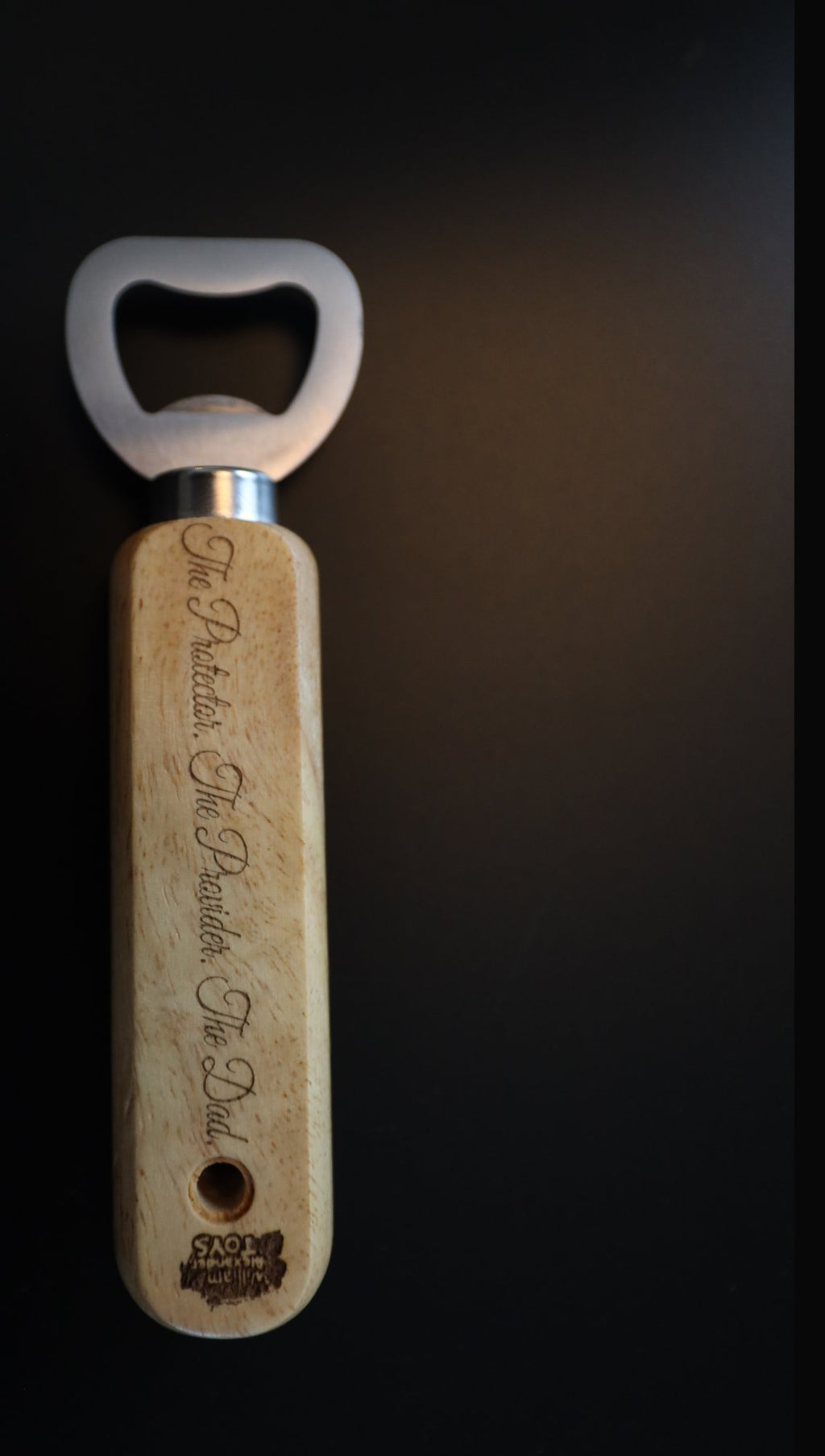 Wooden handle bottle opener with steel head, engraved sample text, upright on black