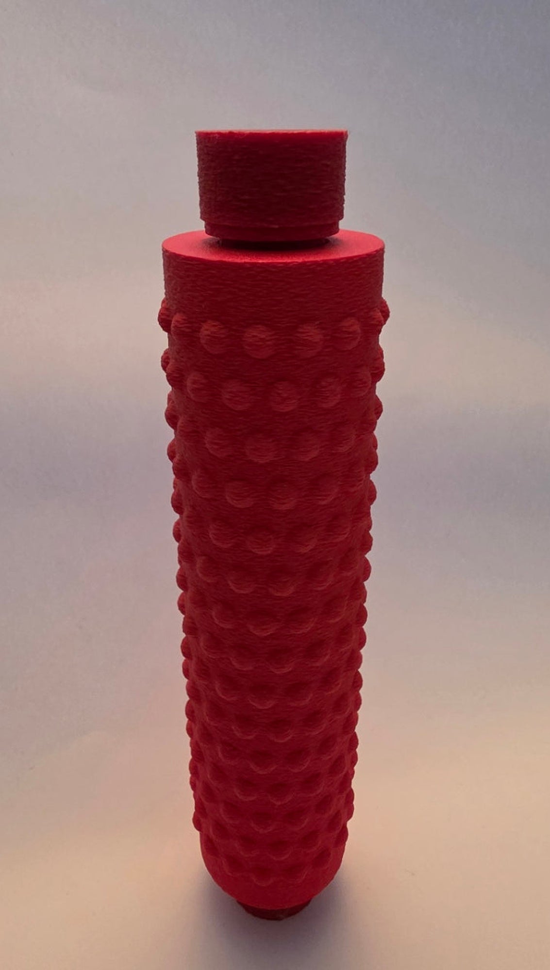 Red massage roller, closer view of the top cap