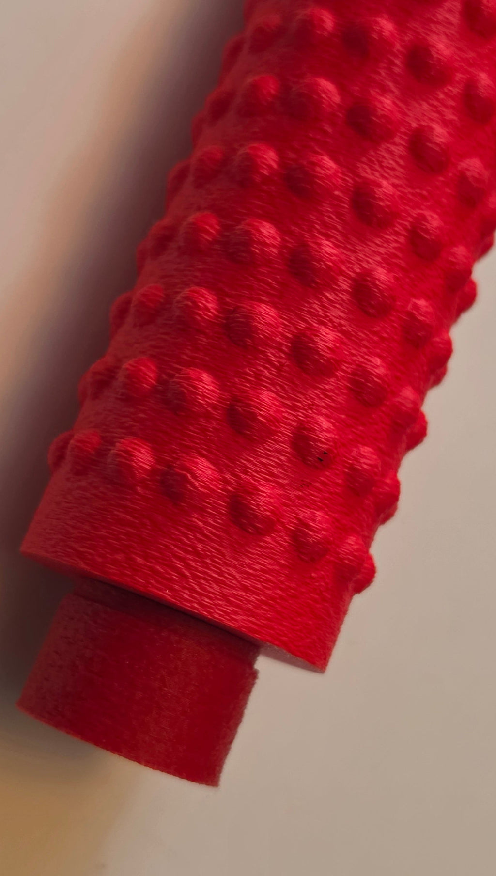 Red massage roller, close-up of the bumps