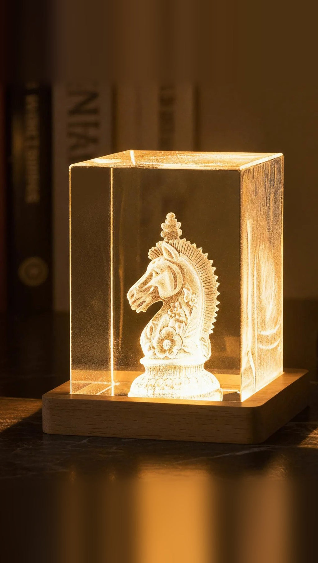 Square K9 crystal tower, 5 × 5 × 8 cm, with a 3D-engraved design glowing on a wooden LED base