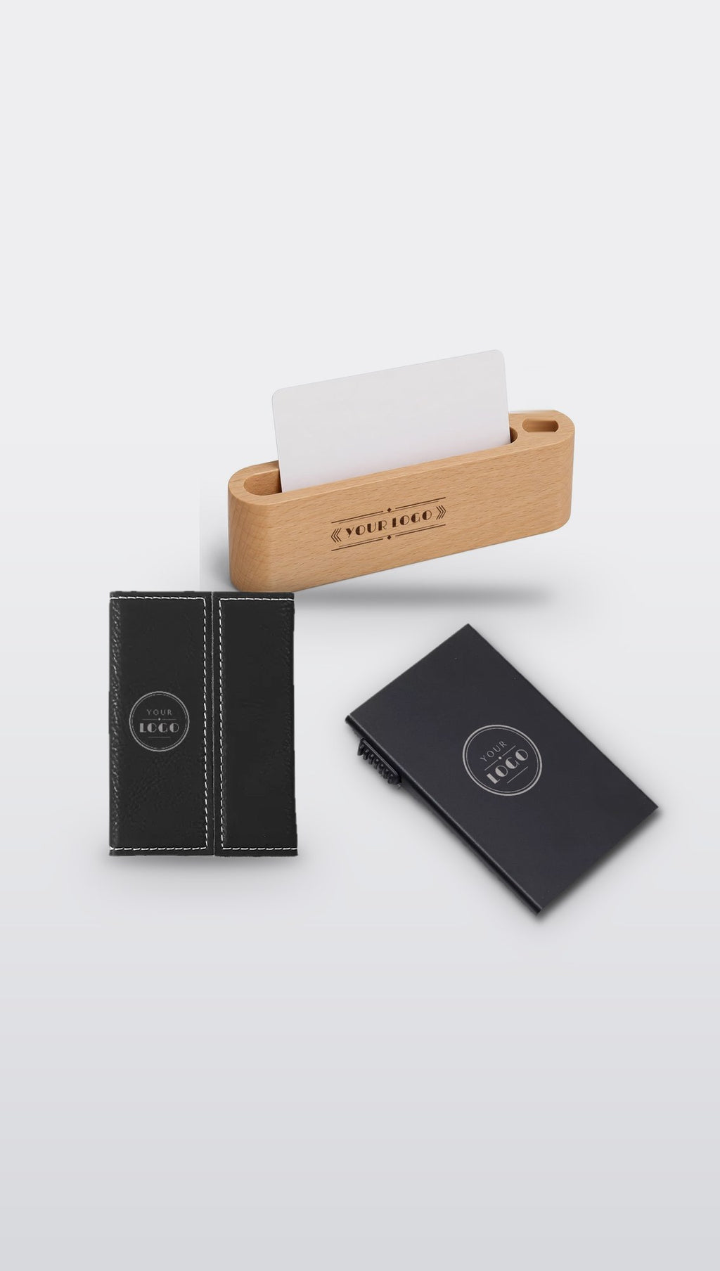 Group of engraved business card holders with sample YOUR LOGO engraving: faux leather, black pop-up metal and beech wooden desk holder
